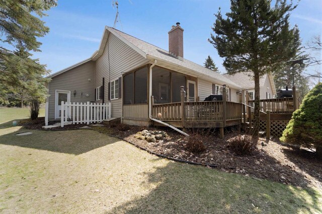 N5120 Summit Ct, Fond Du Lac, WI 54937 - back of property featuring a sunroom, a yard, a deck, and a chimney