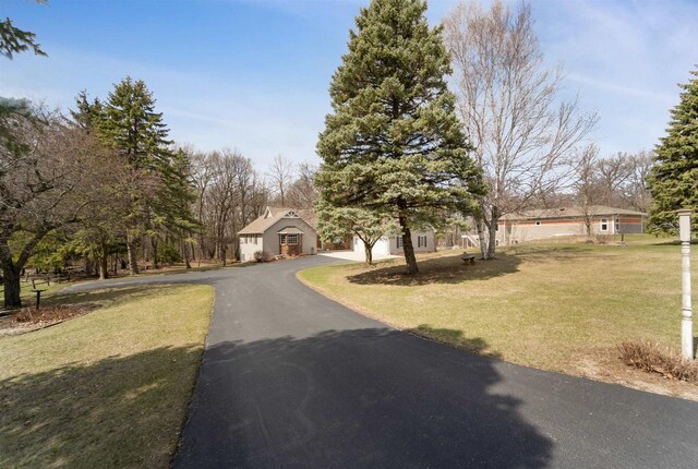 N5120 Summit Ct, Fond Du Lac, WI 54937 - view of front of house with a garage, aphalt driveway, and a front lawn