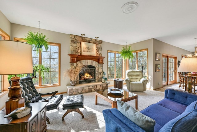 carpeted living area with baseboards and a fireplace