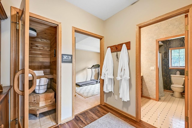 interior space featuring wood finished floors, a sauna, and baseboards