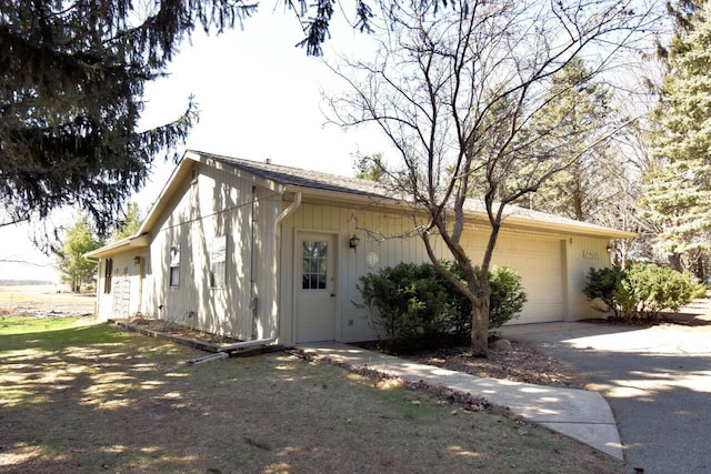 view of property exterior with concrete driveway and an attached garage