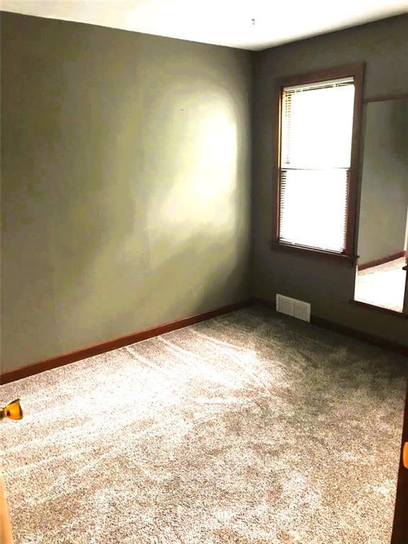 1708 5th St, Menomonie, WI 54751 - carpeted empty room with baseboards and visible vents