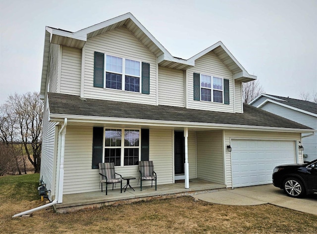 traditional home with a porch, concrete driveway, and a garage