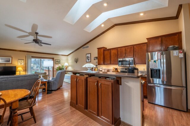 421 Nature Haven Blvd Unit 15, Kewaskum, WI 53040 - kitchen featuring appliances with stainless steel finishes, visible vents, dark countertops, open floor plan, and ornamental molding
