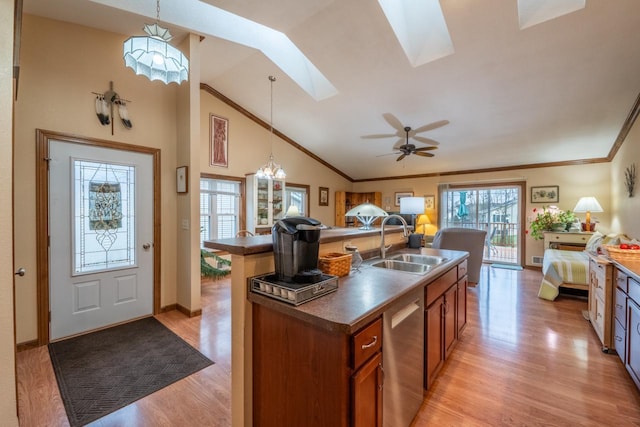 421 Nature Haven Blvd Unit 15, Kewaskum, WI 53040 - kitchen featuring light wood-style flooring, a sink, open floor plan, an island with sink, and brown cabinetry