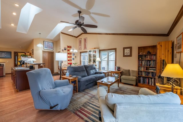 421 Nature Haven Blvd Unit 15, Kewaskum, WI 53040 - living area featuring vaulted ceiling with skylight, recessed lighting, ornamental molding, light wood finished floors, and a ceiling fan