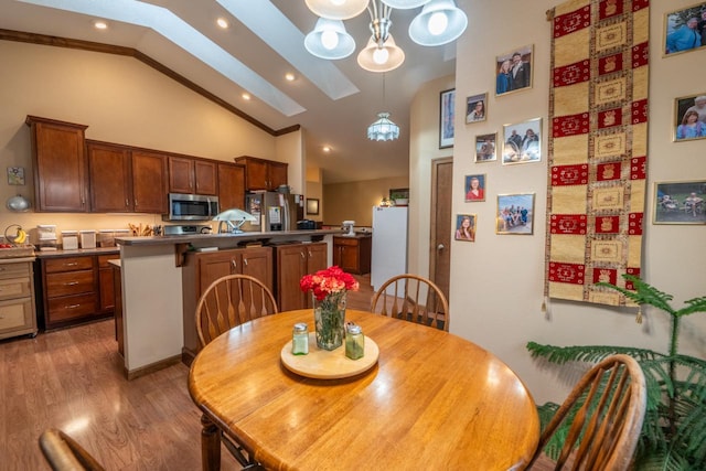 421 Nature Haven Blvd Unit 15, Kewaskum, WI 53040 - dining space with an inviting chandelier, wood finished floors, recessed lighting, and vaulted ceiling