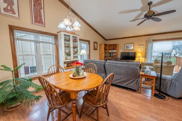 421 Nature Haven Blvd Unit 15, Kewaskum, WI 53040 - dining room with crown molding, ceiling fan with notable chandelier, high vaulted ceiling, and light wood-style floors