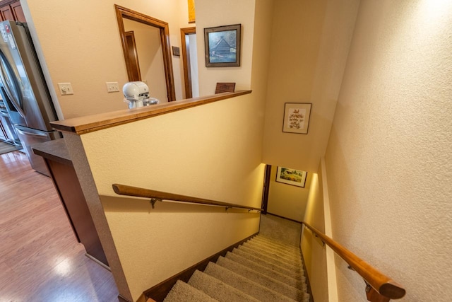 421 Nature Haven Blvd Unit 15, Kewaskum, WI 53040 - staircase with wood finished floors and a textured wall
