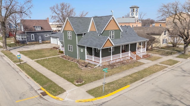 131 Madison Ave, Omro, WI 54963 - view of front of property featuring a garage, covered porch, roof with shingles, a front yard, and driveway