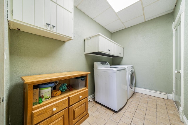 131 Madison Ave, Omro, WI 54963 - laundry area with cabinet space, washing machine and clothes dryer, light tile patterned flooring, and baseboards