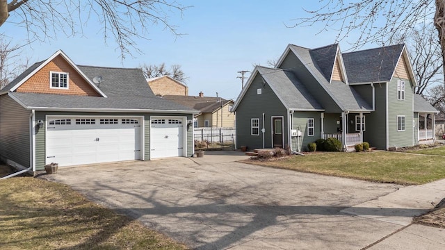 131 Madison Ave, Omro, WI 54963 - view of front of home with driveway, an attached garage, a front yard, a shingled roof, and covered porch