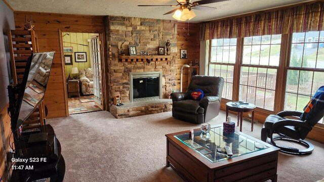 755 Brickley Dr, Fontana, WI 53125 - carpeted living area featuring wood walls, ceiling fan, and plenty of natural light