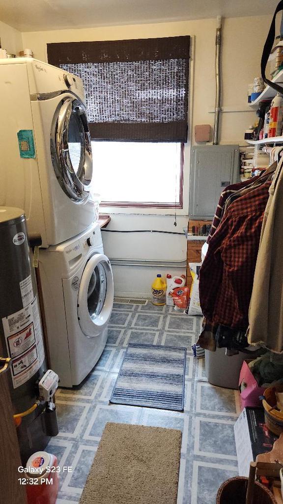 755 Brickley Dr, Fontana, WI 53125 - clothes washing area featuring stacked washer / dryer, tile patterned floors, laundry area, and gas water heater