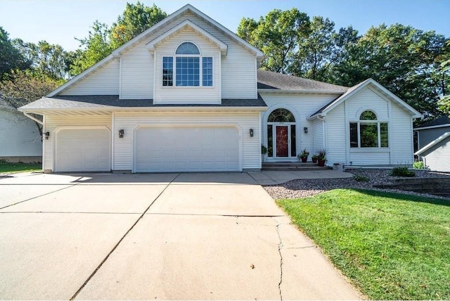 3921 Damon Ct, Eau Claire, WI 54701 - view of front of home with an attached garage, a shingled roof, driveway, and a front lawn