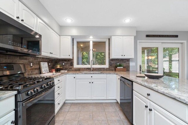 3921 Damon Ct, Eau Claire, WI 54701 - kitchen with tasteful backsplash, white cabinetry, appliances with stainless steel finishes, light stone counters, and a sink