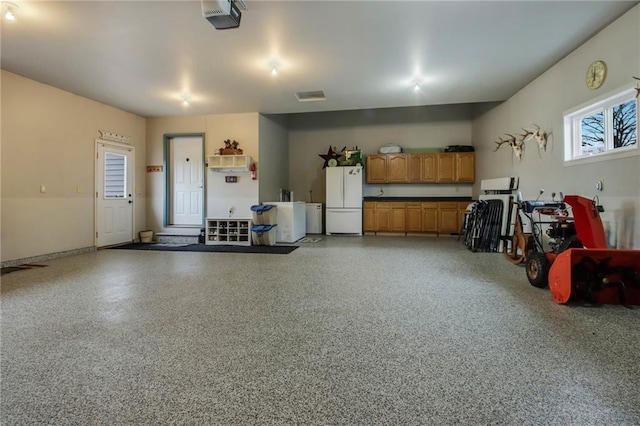 1229 W Beltline Rd, Spring Valley, WI 54767 - garage with a garage door opener and freestanding refrigerator