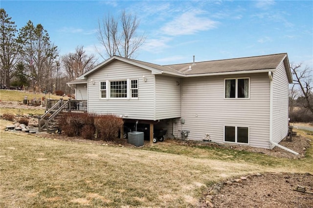 1229 W Beltline Rd, Spring Valley, WI 54767 - rear view of property featuring stairs, central AC unit, and a lawn