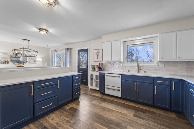 311 Blue View Dr, Mount Horeb, WI 53572 - kitchen with white cabinets, dark wood-style flooring, blue cabinetry, and a sink
