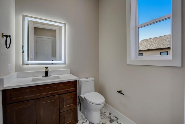 2025 Mulberry St, Sauk City, WI 53583 - half bathroom featuring toilet, marble finish floor, baseboards, and vanity