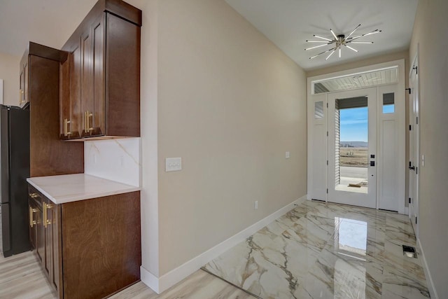 2025 Mulberry St, Sauk City, WI 53583 - foyer with an inviting chandelier, marble finish floor, and baseboards