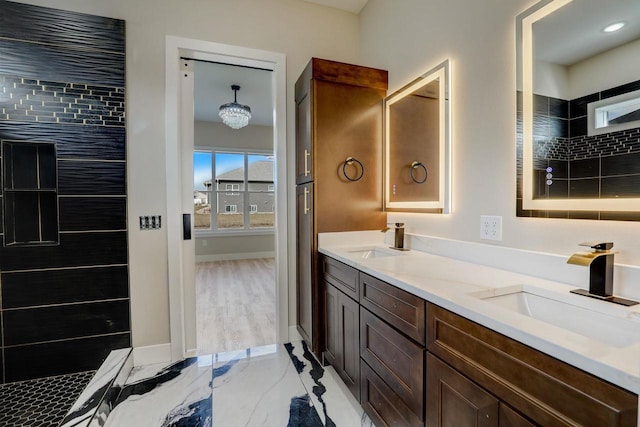 2025 Mulberry St, Sauk City, WI 53583 - full bathroom with baseboards, double vanity, marble finish floor, and a sink