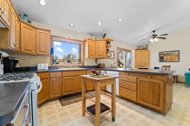 4208 County Road Z, Oshkosh, WI 54904 - kitchen with white appliances, a peninsula, dark countertops, light floors, and a sink