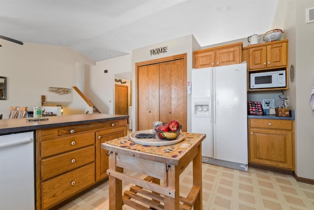 4208 County Road Z, Oshkosh, WI 54904 - kitchen featuring light floors, white appliances, visible vents, brown cabinets, and lofted ceiling