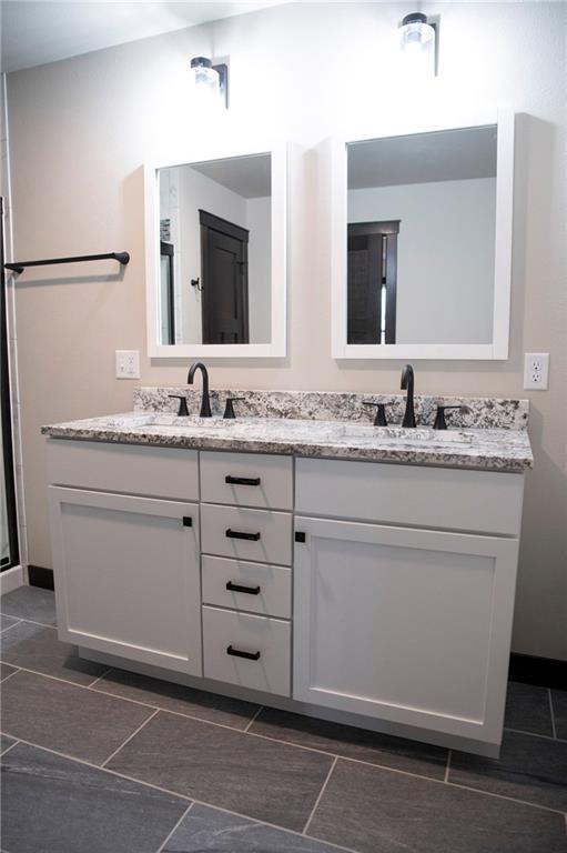 17297 109th Ave, Chippewa Falls, WI 54729 - full bathroom featuring double vanity and a sink