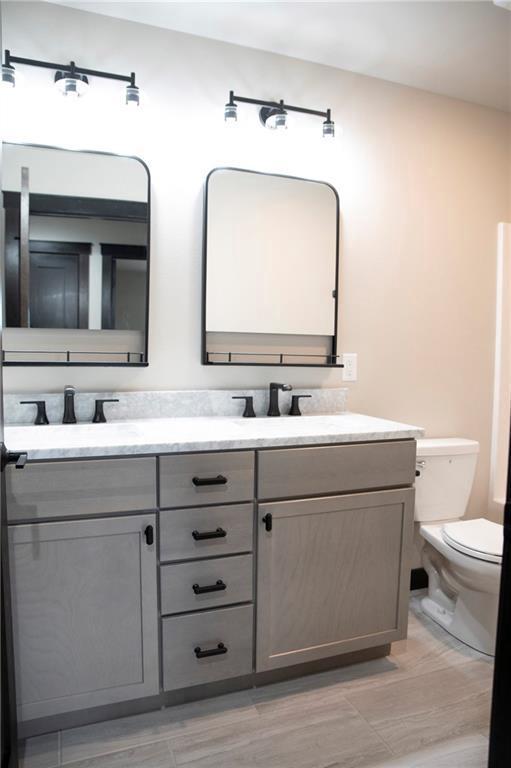 17297 109th Ave, Chippewa Falls, WI 54729 - bathroom with toilet, double vanity, and a sink
