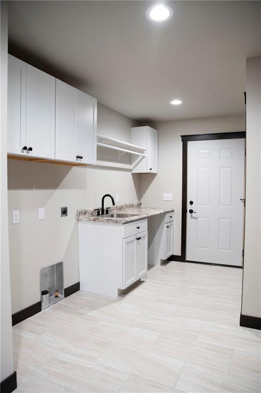 17297 109th Ave, Chippewa Falls, WI 54729 - clothes washing area featuring baseboards, a sink, recessed lighting, cabinet space, and electric dryer hookup