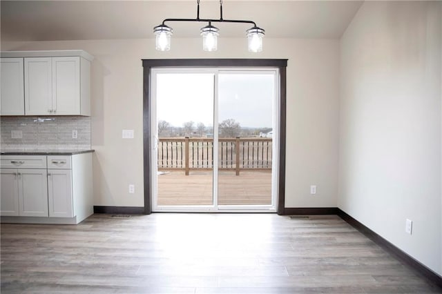 17297 109th Ave, Chippewa Falls, WI 54729 - unfurnished dining area with light wood-type flooring and baseboards