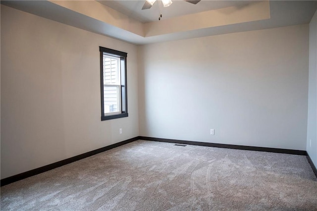 17297 109th Ave, Chippewa Falls, WI 54729 - spare room with carpet, a tray ceiling, baseboards, and ceiling fan