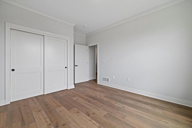 743 Brockway Dr Unit Lt37, Mukwonago, WI 53149 - unfurnished bedroom featuring crown molding, baseboards, wood finished floors, and a closet