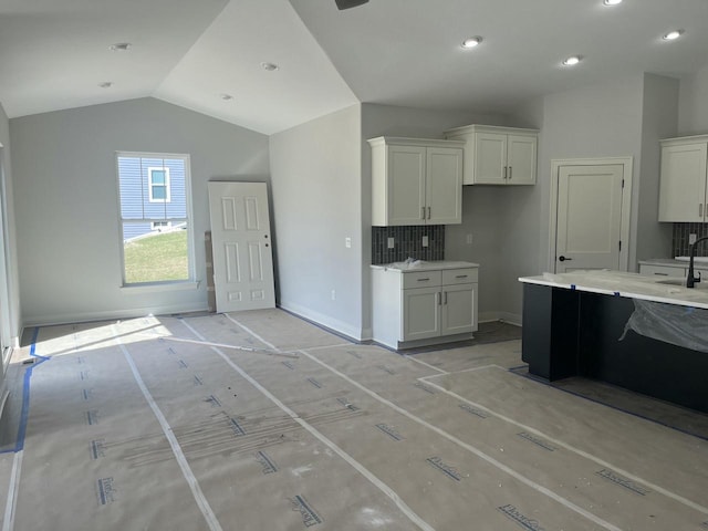 743 Brockway Dr Unit Lt37, Mukwonago, WI 53149 - kitchen with lofted ceiling, white cabinets, a sink, light countertops, and baseboards