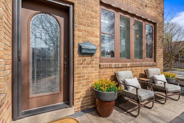 property entrance with brick siding
