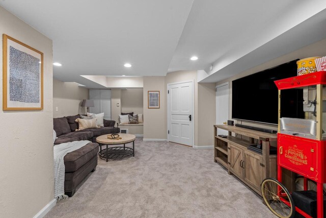 carpeted living area featuring baseboards and recessed lighting