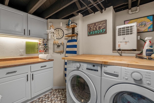 laundry room featuring tile patterned floors, cabinet space, and independent washer and dryer