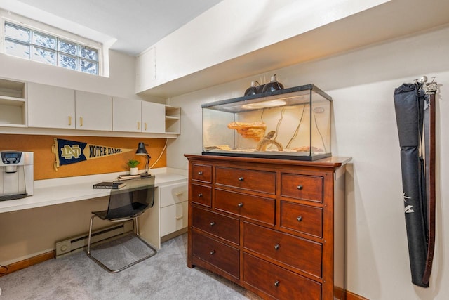home office with baseboard heating, light carpet, and built in desk