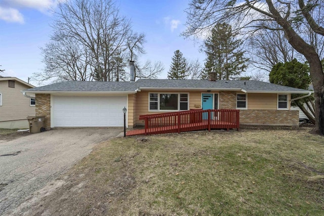 5221 Odana Rd, Madison, WI 53711 - view of front of property with brick siding, driveway, an attached garage, and a front lawn