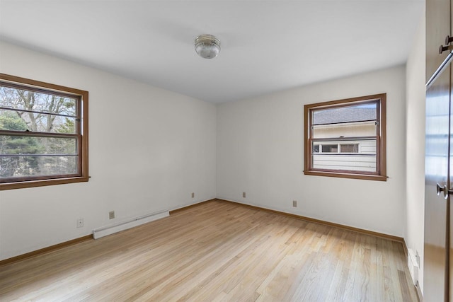 5221 Odana Rd, Madison, WI 53711 - unfurnished room featuring light wood finished floors, visible vents, a baseboard heating unit, and baseboards