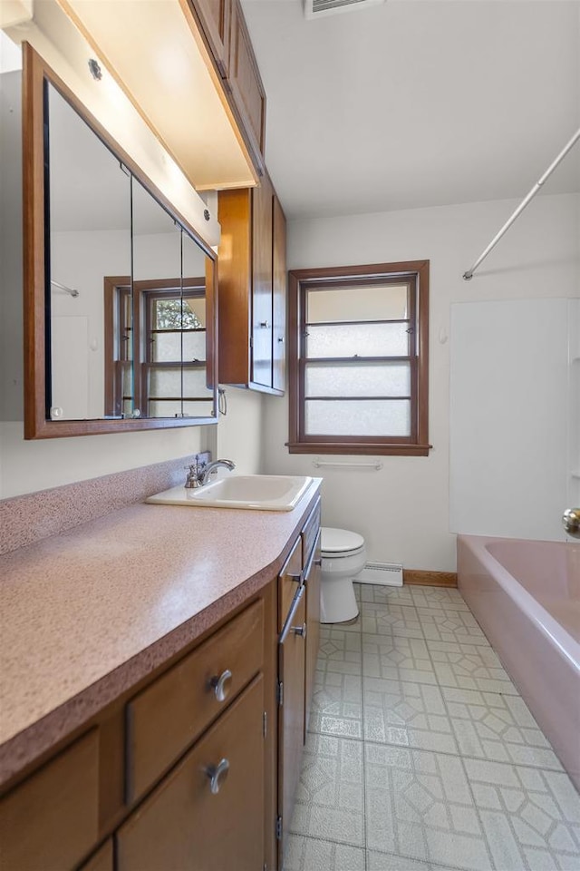5221 Odana Rd, Madison, WI 53711 - bathroom with toilet, vanity, baseboards, and plenty of natural light
