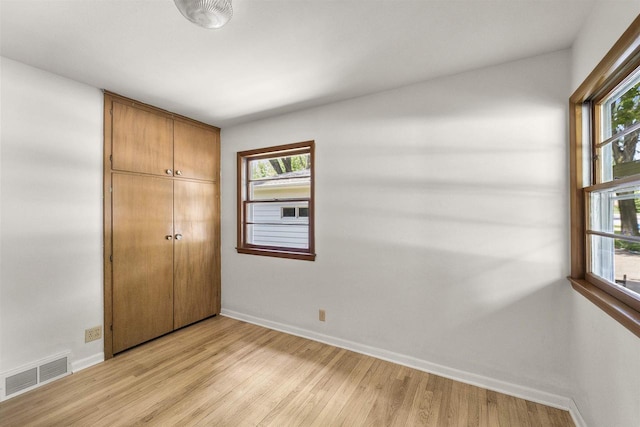 5221 Odana Rd, Madison, WI 53711 - unfurnished bedroom featuring baseboards, light wood-type flooring, and a closet