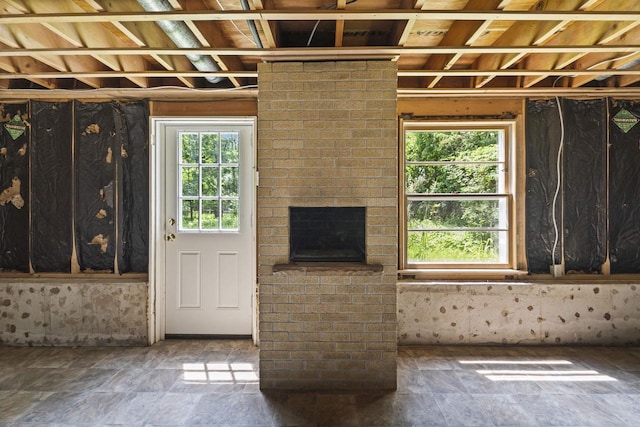 5221 Odana Rd, Madison, WI 53711 - unfurnished living room with stone finish flooring and a fireplace