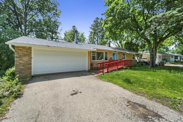 5221 Odana Rd, Madison, WI 53711 - ranch-style house featuring brick siding, a chimney, asphalt driveway, and a wooden deck