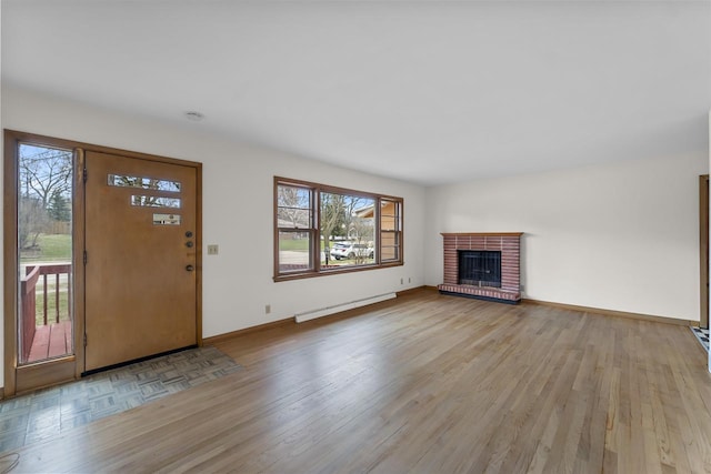 5221 Odana Rd, Madison, WI 53711 - unfurnished living room with a baseboard radiator, a brick fireplace, light wood-style floors, and baseboards