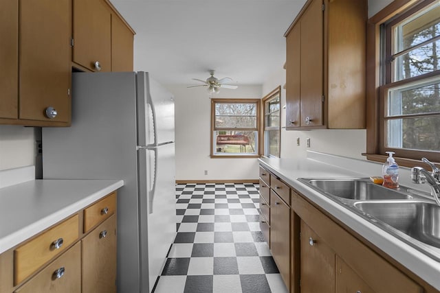 5221 Odana Rd, Madison, WI 53711 - kitchen featuring plenty of natural light, light countertops, freestanding refrigerator, ceiling fan, and dark floors