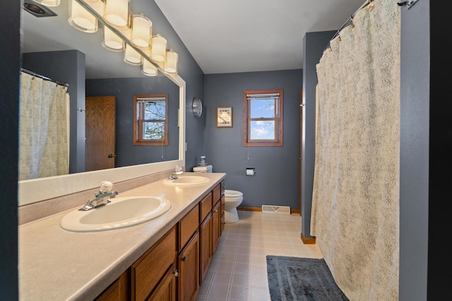 full bathroom with visible vents, baseboards, a sink, and toilet