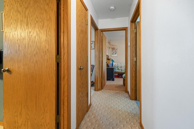 corridor with light colored carpet
