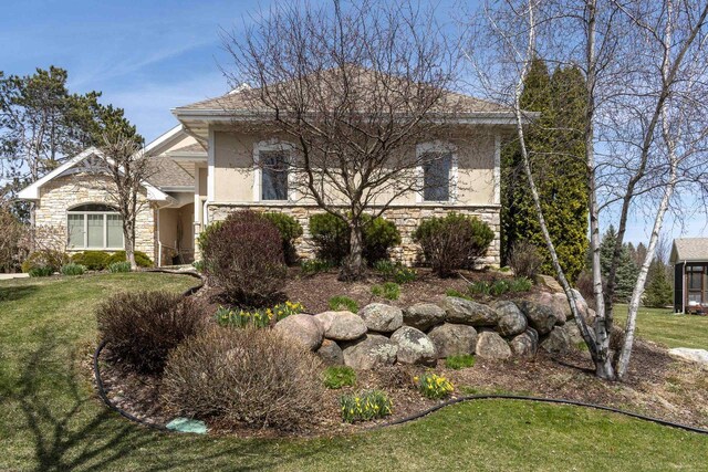 1105 Meadow Mist Rd, Middleton, WI 53562 - view of front of property with stucco siding, a front lawn, and stone siding